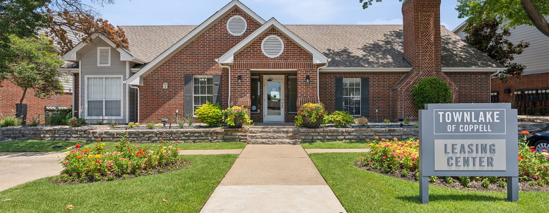 a brick building with a sign in front of it