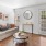 a living room with a couch table tv and windows