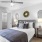 a bedroom with a bed and a fan