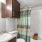 a bathroom with a sink large mirror and a shower