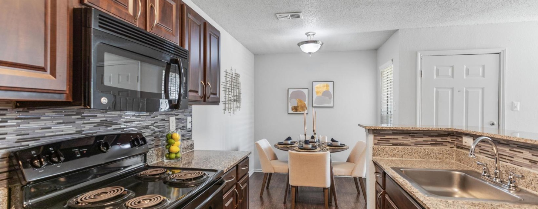 a kitchen with a stove microwave and sink